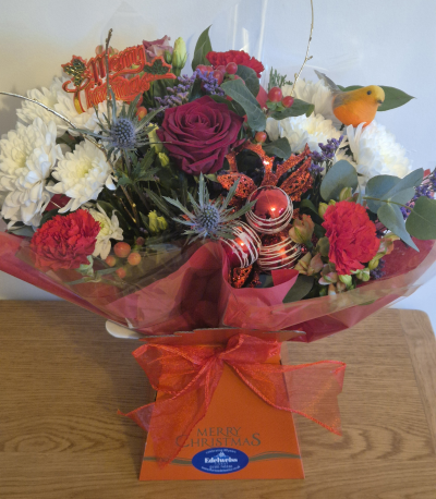 Jingle bells - A beautiful selection of seasonal Christmas flowers and fragrant greens. In a water box ready to admire.