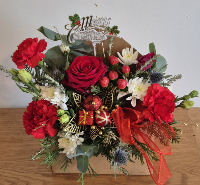 Christmas letter - An oasis envelope filled with beautiful Christmas flowers, greens and decorations. Ready to admire.