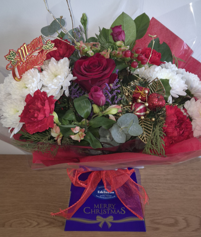 Christmas surprise - Lovely selection of Christmas flowers in seasonal blooms and fragrant greens.
