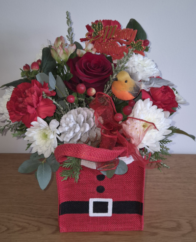Santa baby - Stunning Christmas gift bag filled with oasis and seasonal flowers. Personally delivered to your loved one.