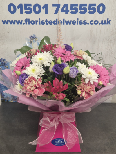 Summer Breeze - A beautifully handcrafted bouquet featuring fresh seasonal flowers in vibrant pink, lavender and white tones, carefully arranged to create a bright and elegant gift. Flowers are subject to seasonal availability.