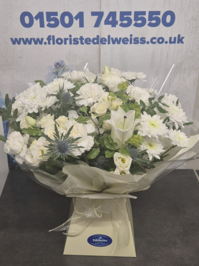 Scottish Creams - A beautifully handcrafted bouquet in timeless white and ivory tones, expertly arranged with seasonal flowers to offer a graceful and elegant gift for any occasion.